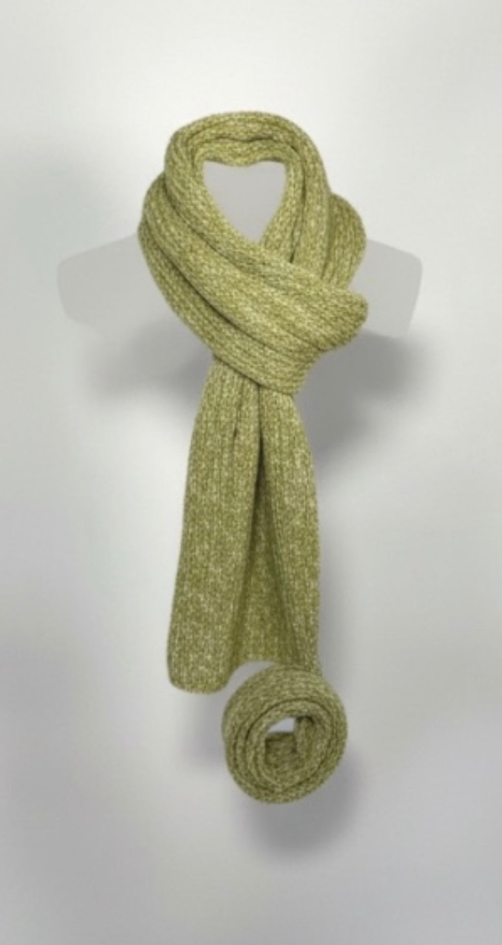 Green dill and bone knitted scarf flat against a white background