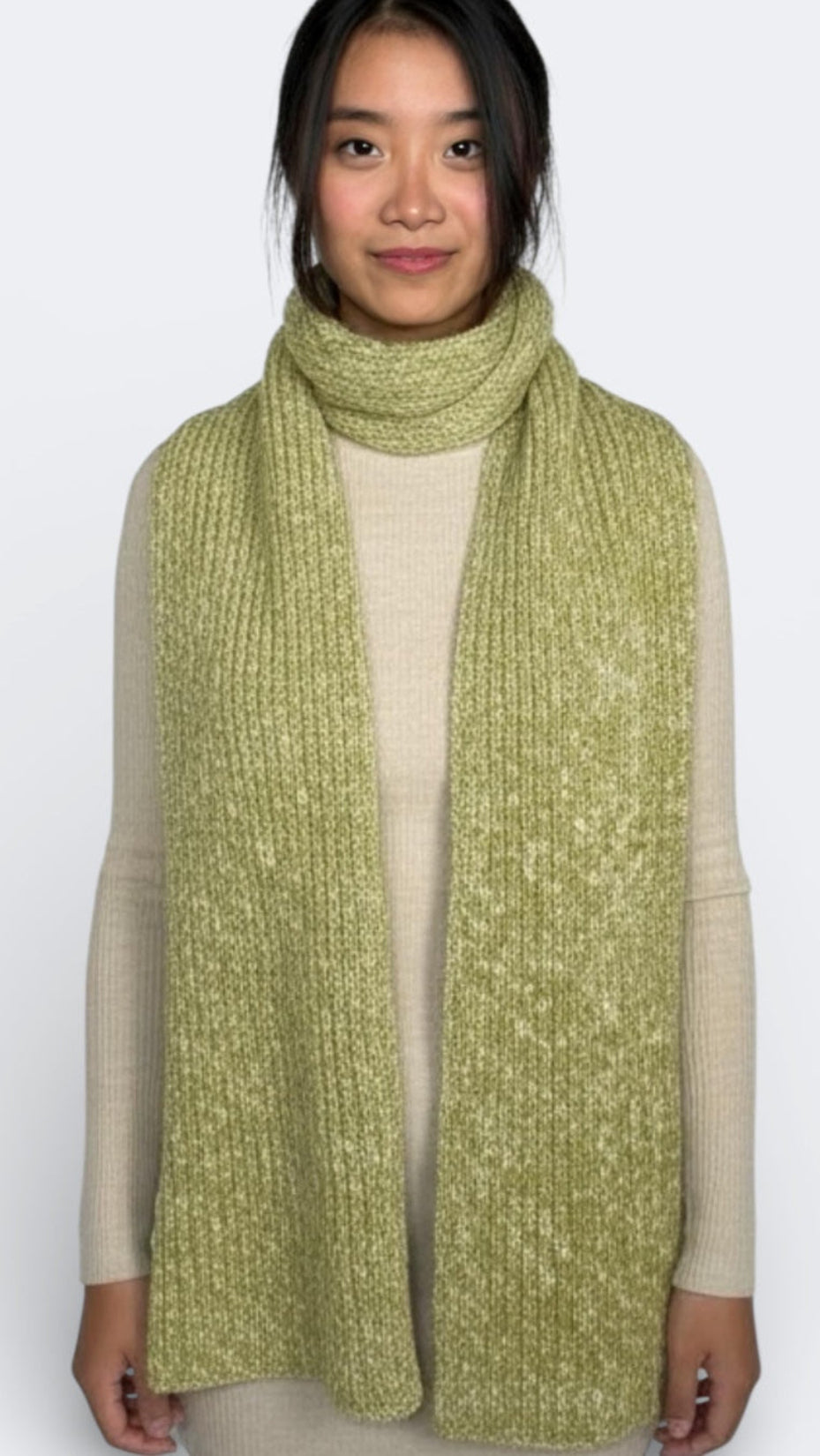 Woman wearing a green dill and bone knitted scarf by The Knit House LA on a white background