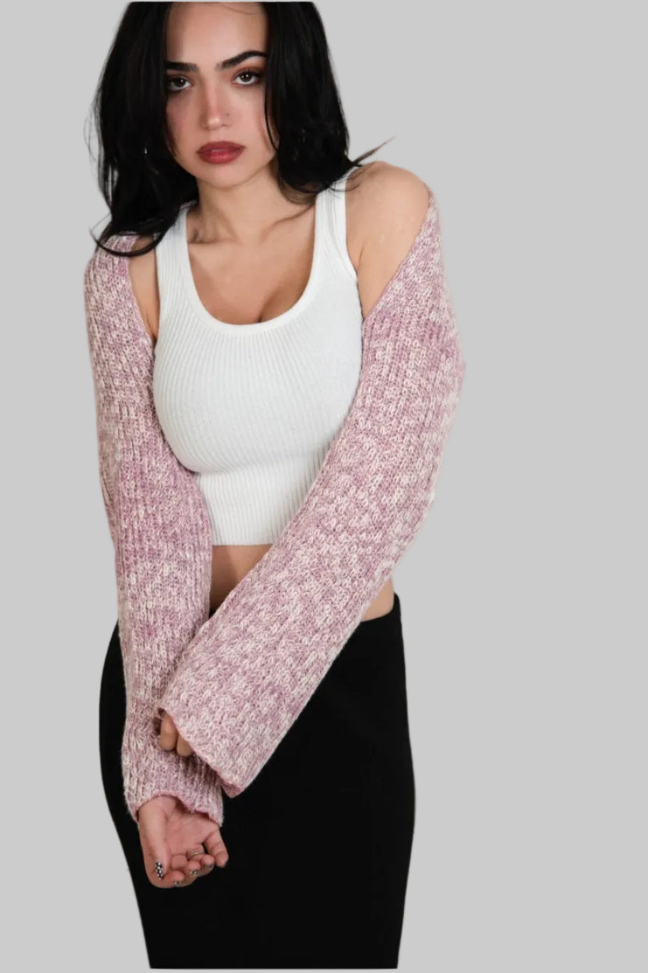Woman wearing a pink and white mixed knit long sleeve shrug over a white scoop neck tank by The Knit House LA.