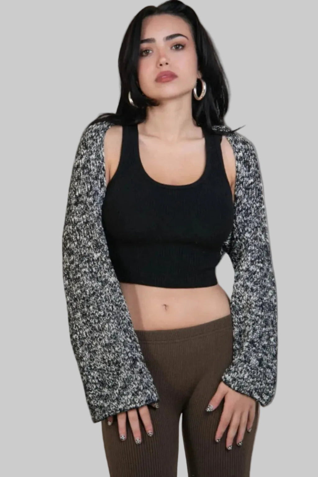 woman wearing an open long sleeve crop shrug in a black and white mixed knit by The Knit House LA.