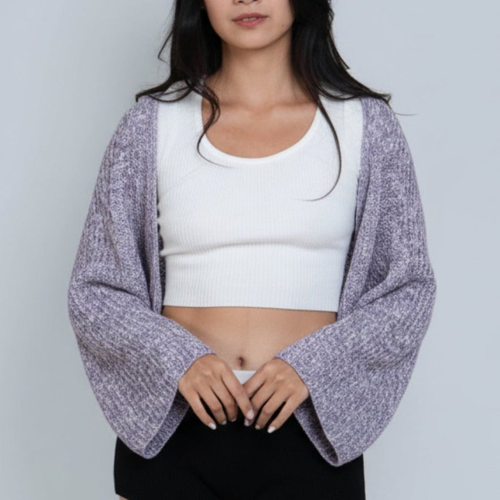 Woman wearing a long sleeve crop knit shrug in Violet purple and bone mixed knit by The Knit House LA.