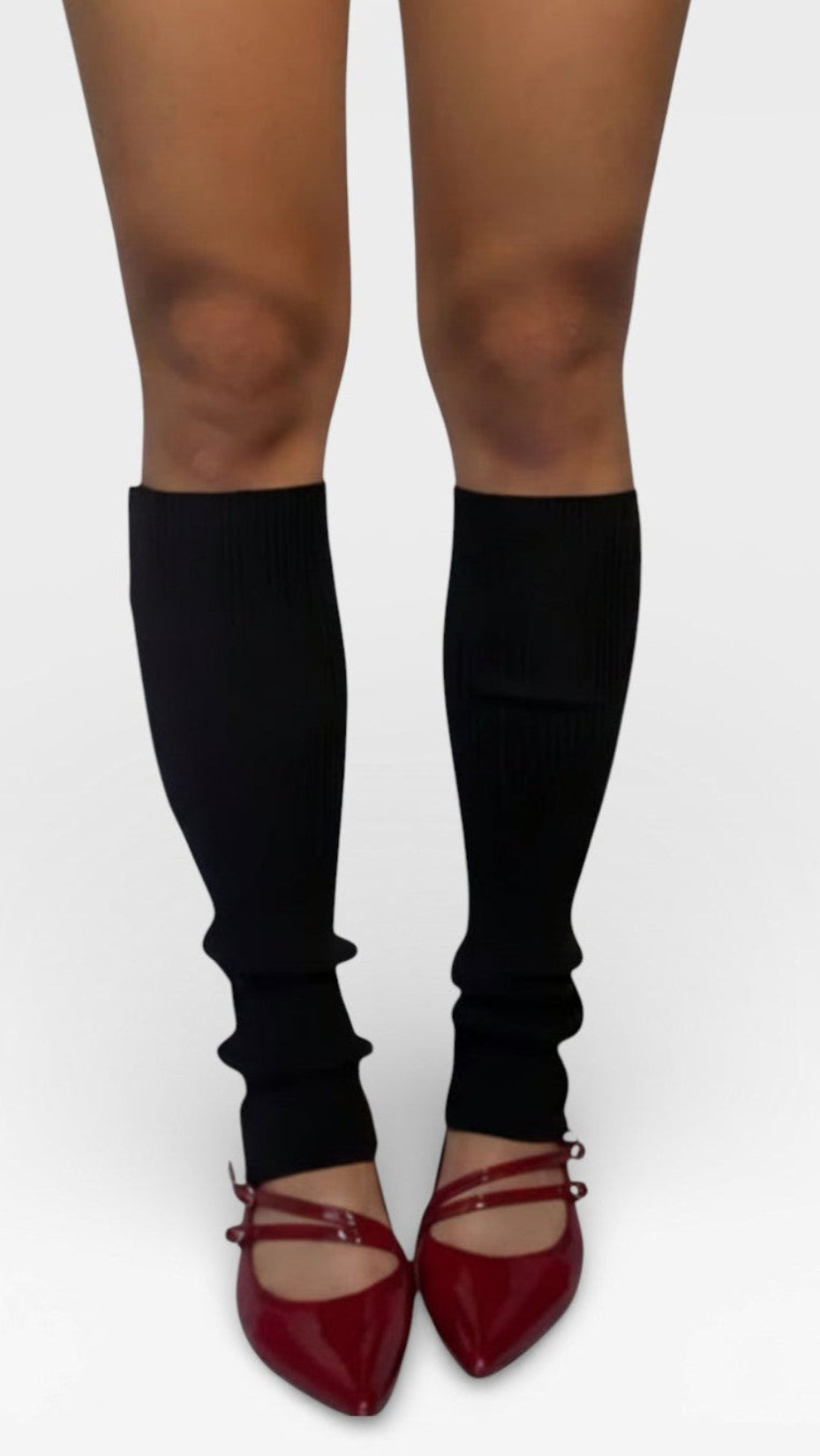 Ink Black knee-high rib knit legwarmers worn by The Knit House LA with red shoes on a white background