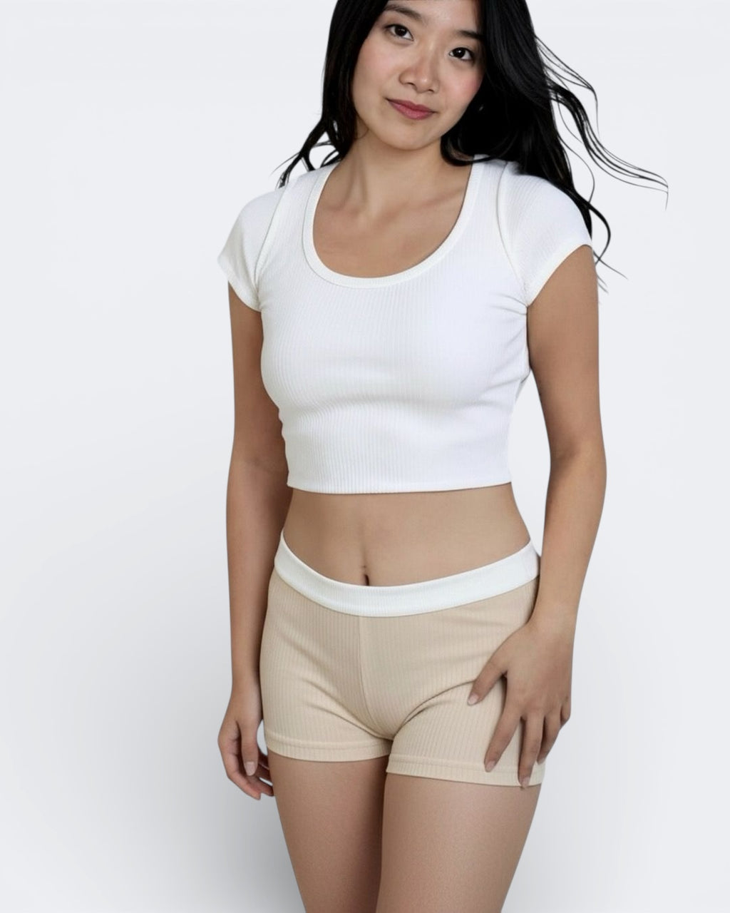 woman wearing rib knit boy shorts in drift beige with white waistband by The Knit House LA.