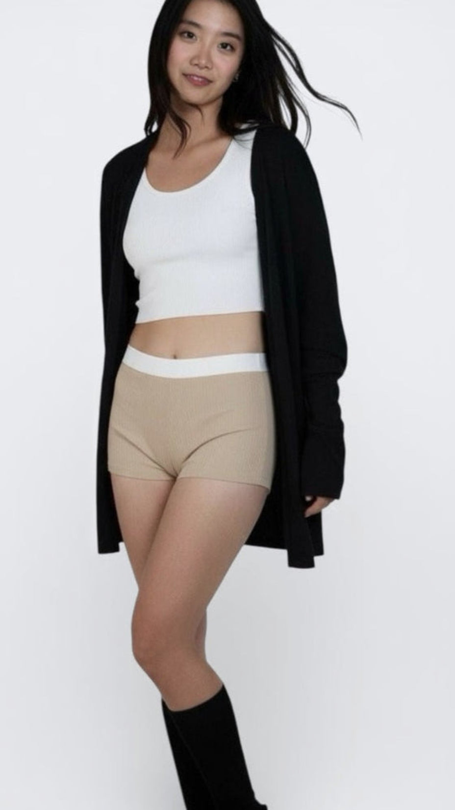 woman wearing rib knit boy shorts in drift beige with white waistband by The Knit House LA.