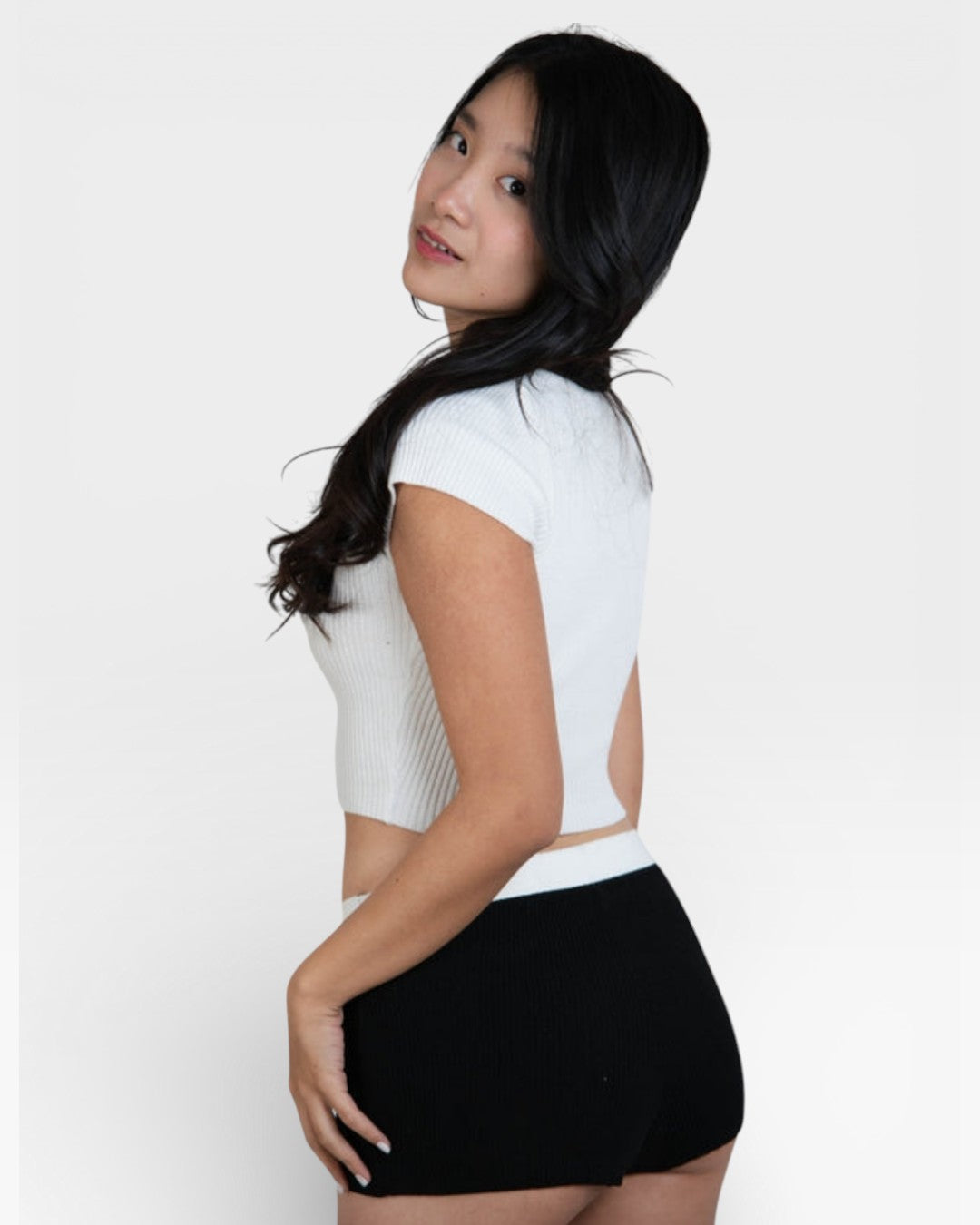 Woman wearing rib knit boy short in Ink black with matching bralette by The Knit House LA.