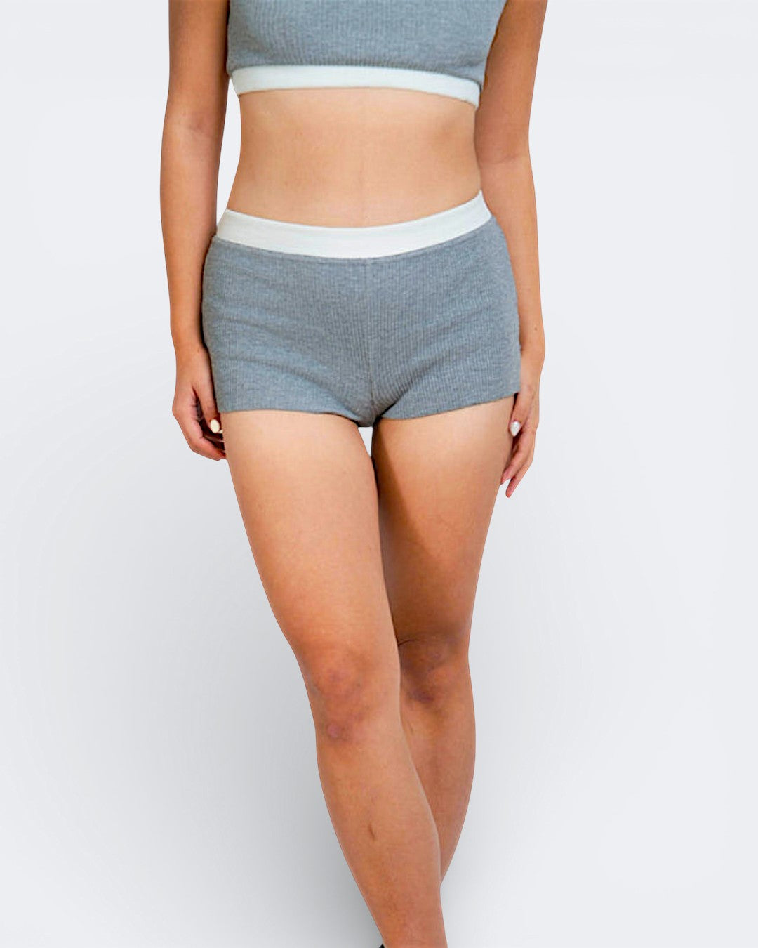 Woman wearing rib knit boy short in mist grey with matching bralette by The Knit House LA.
