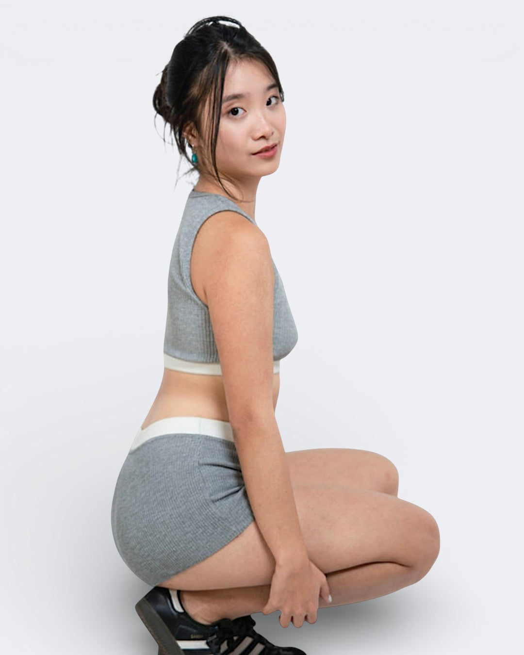 Woman wearing rib knit boy short in mist grey with matching bralette by The Knit House LA.