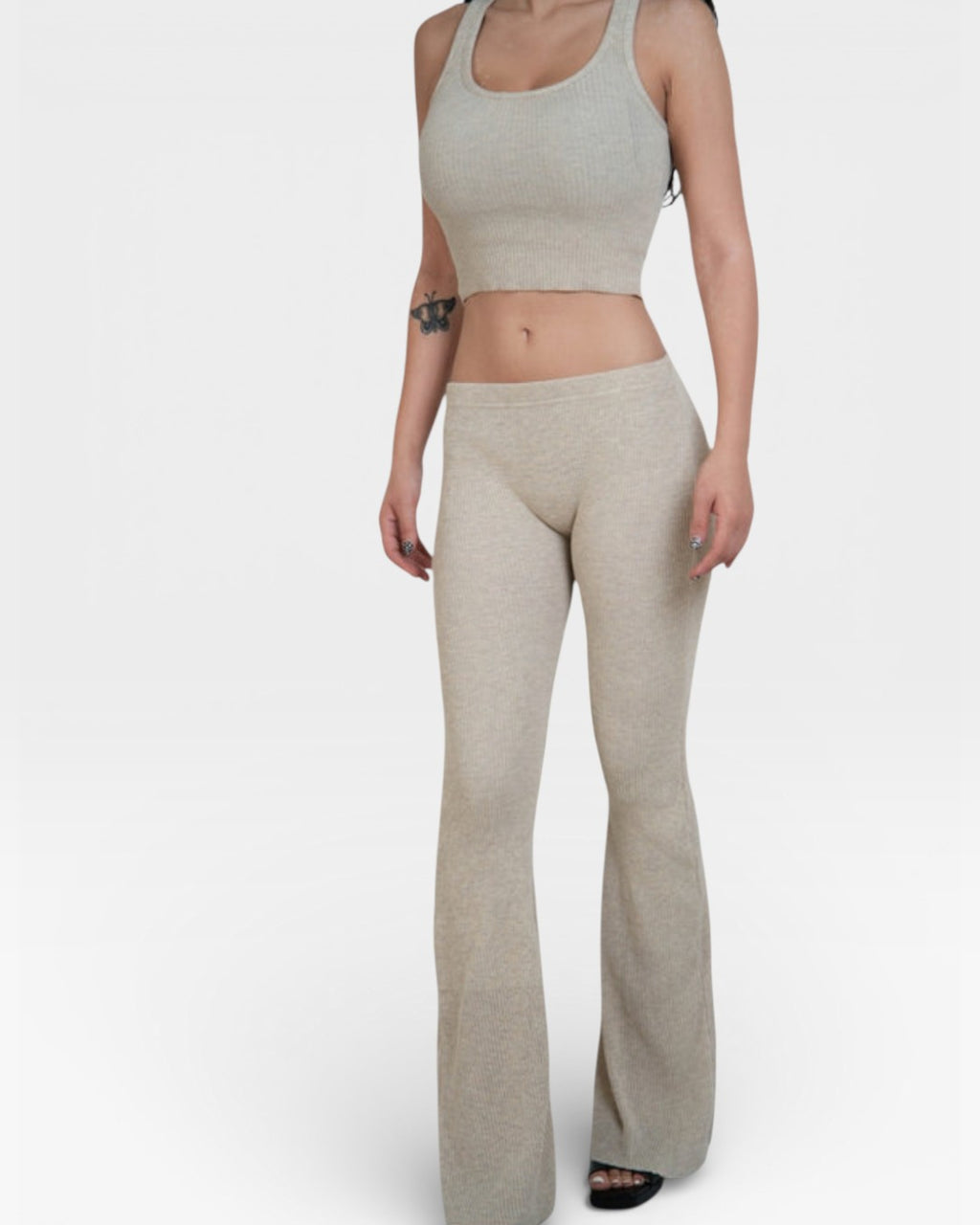 Woman in crop tank and fitted rib knit flared leg pant in Drift beige by The Knit House LA.