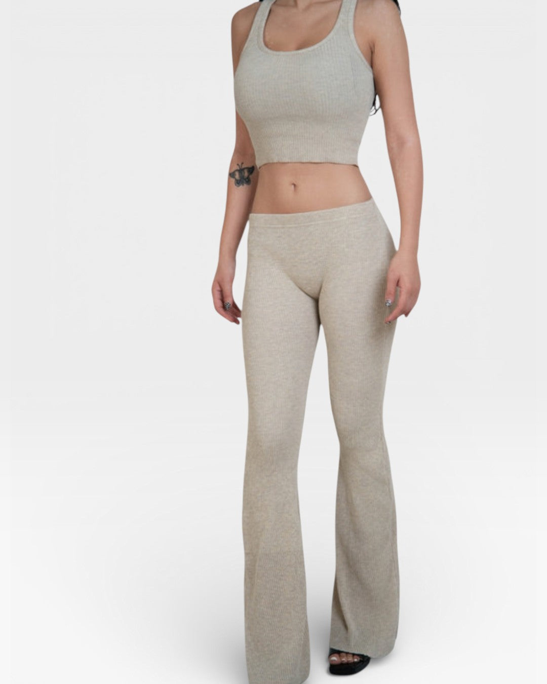 Woman in crop tank and fitted rib knit flared leg pant in Drift beige by The Knit House LA.