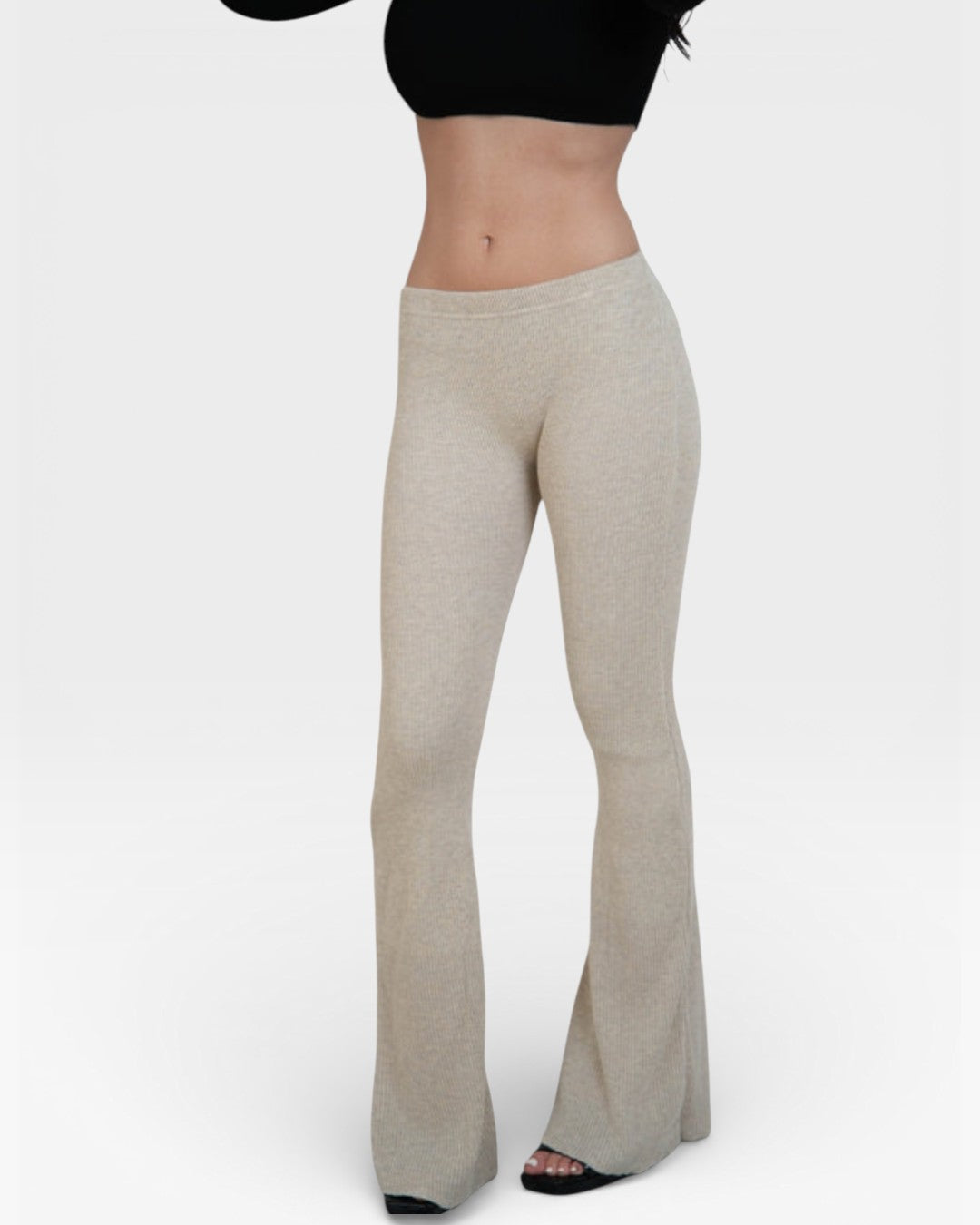 Woman wearing fitted rib knit flared leg pant in Drift beige by The Knit House LA.