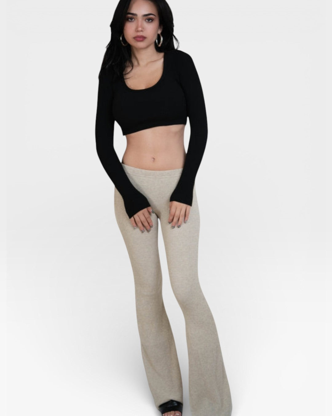 Woman wearing fitted rib knit flared leg pant in Drift beige by The Knit House LA.