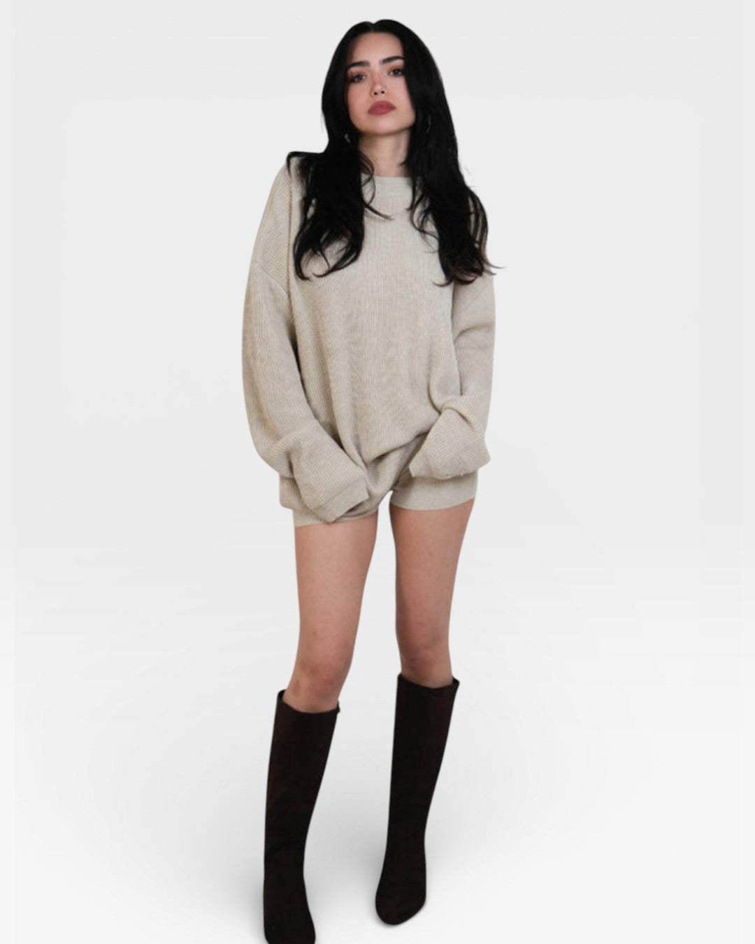 Woman wearing pair of fitted rib knit hot pant shorts in Drift beige by The Knit House LA.