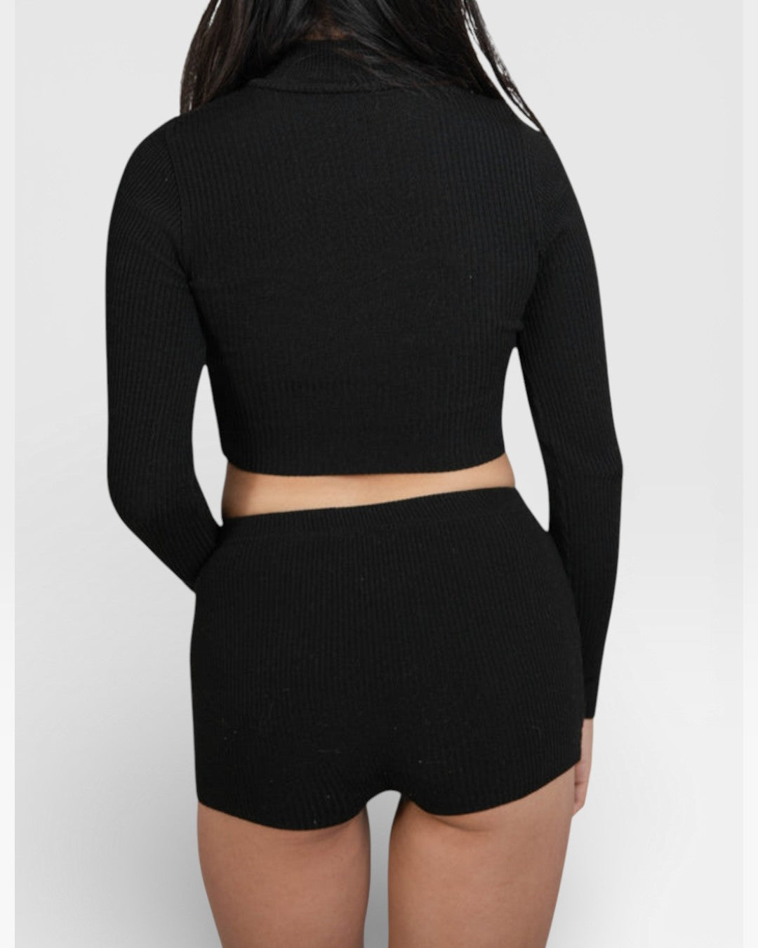 Back view of ​woman wearing fitted rib knit hot pant shorts in Ink black by The Knit House La