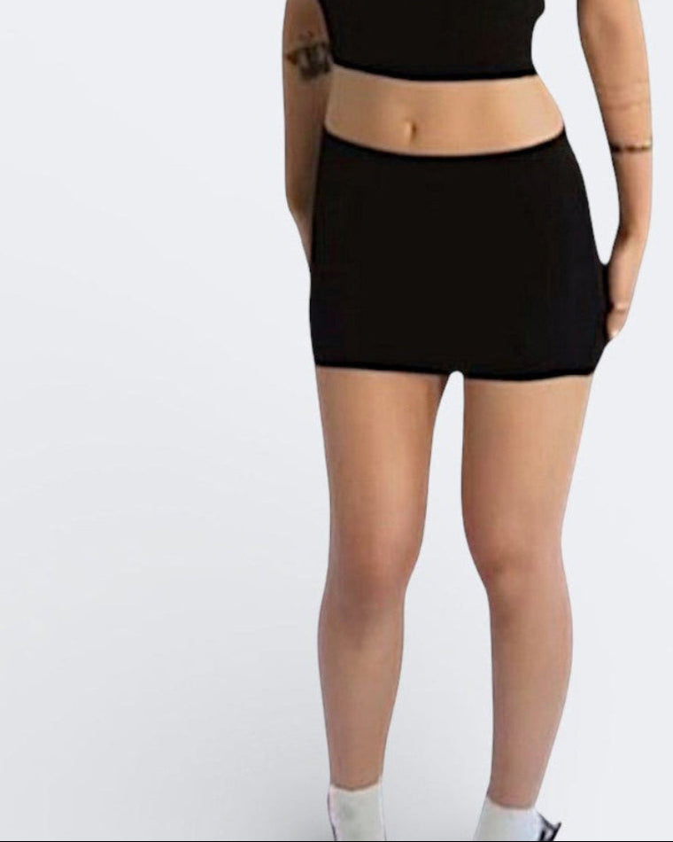 Woman wearing fitted rib knit crop tank wit scoop neckline and mini skirt in Ink black by The Knit House LA.