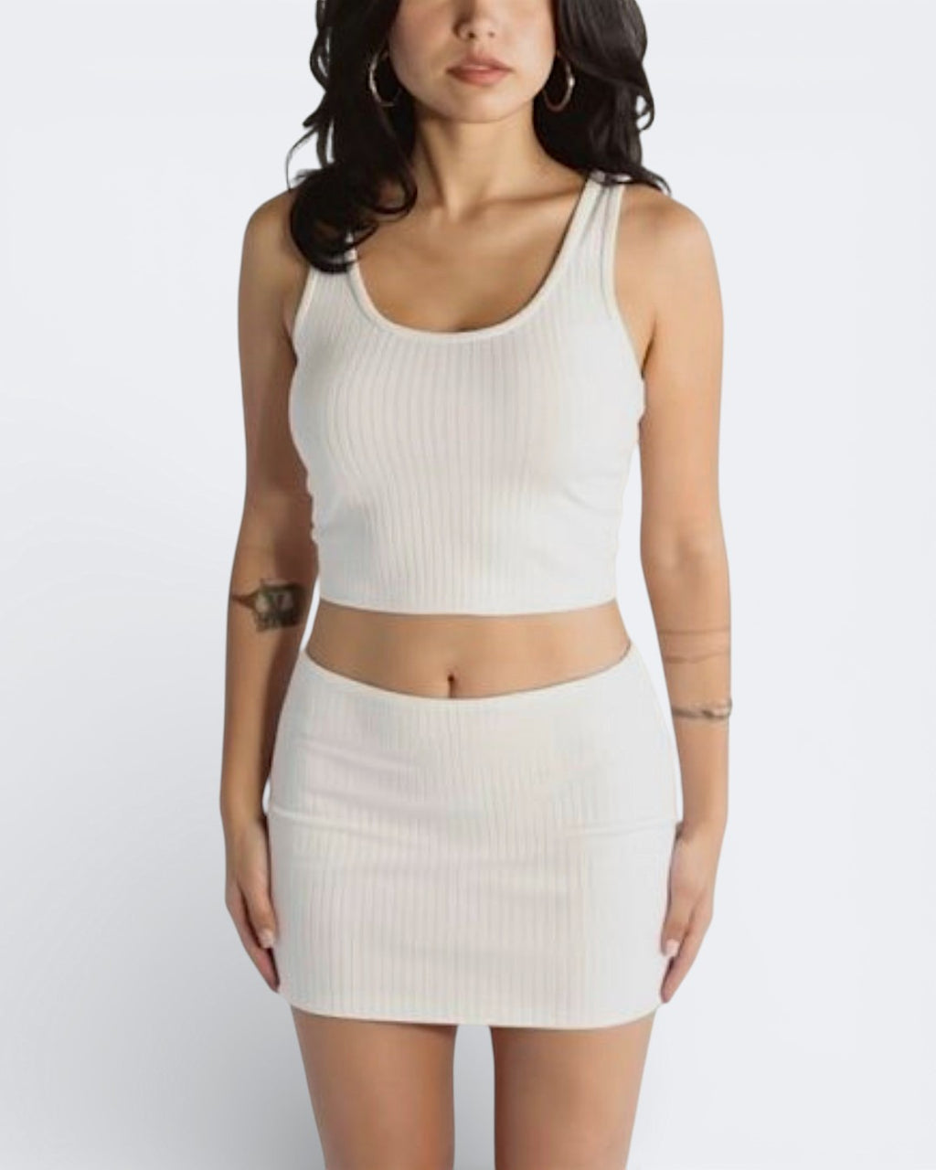 Woman wearing rib knit micro mini and scoop neck tank in Porcelain white by The Knit House LA.