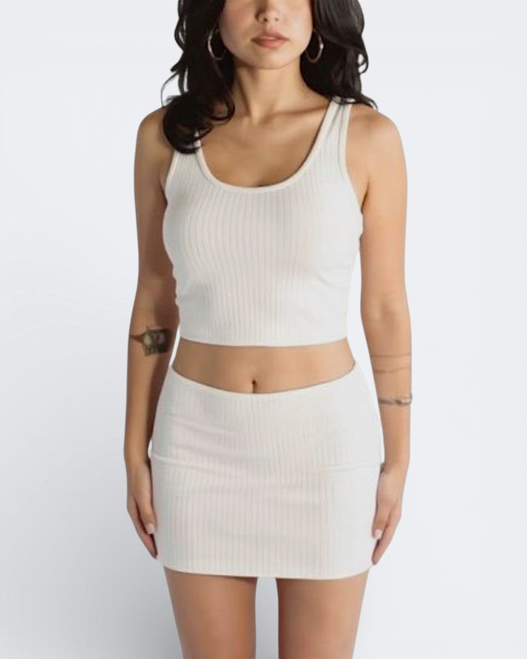 Woman wearing rib knit micro mini and scoop neck tank in Porcelain white by The Knit House LA.