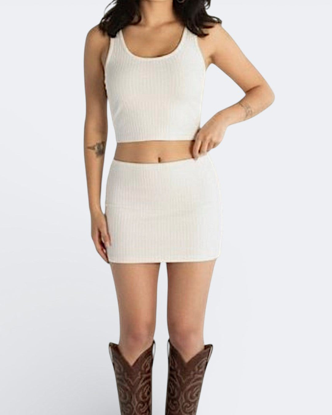 Woman wearing rib knit micro mini and scoop neck tank in Porcelain white by The Knit House LA.