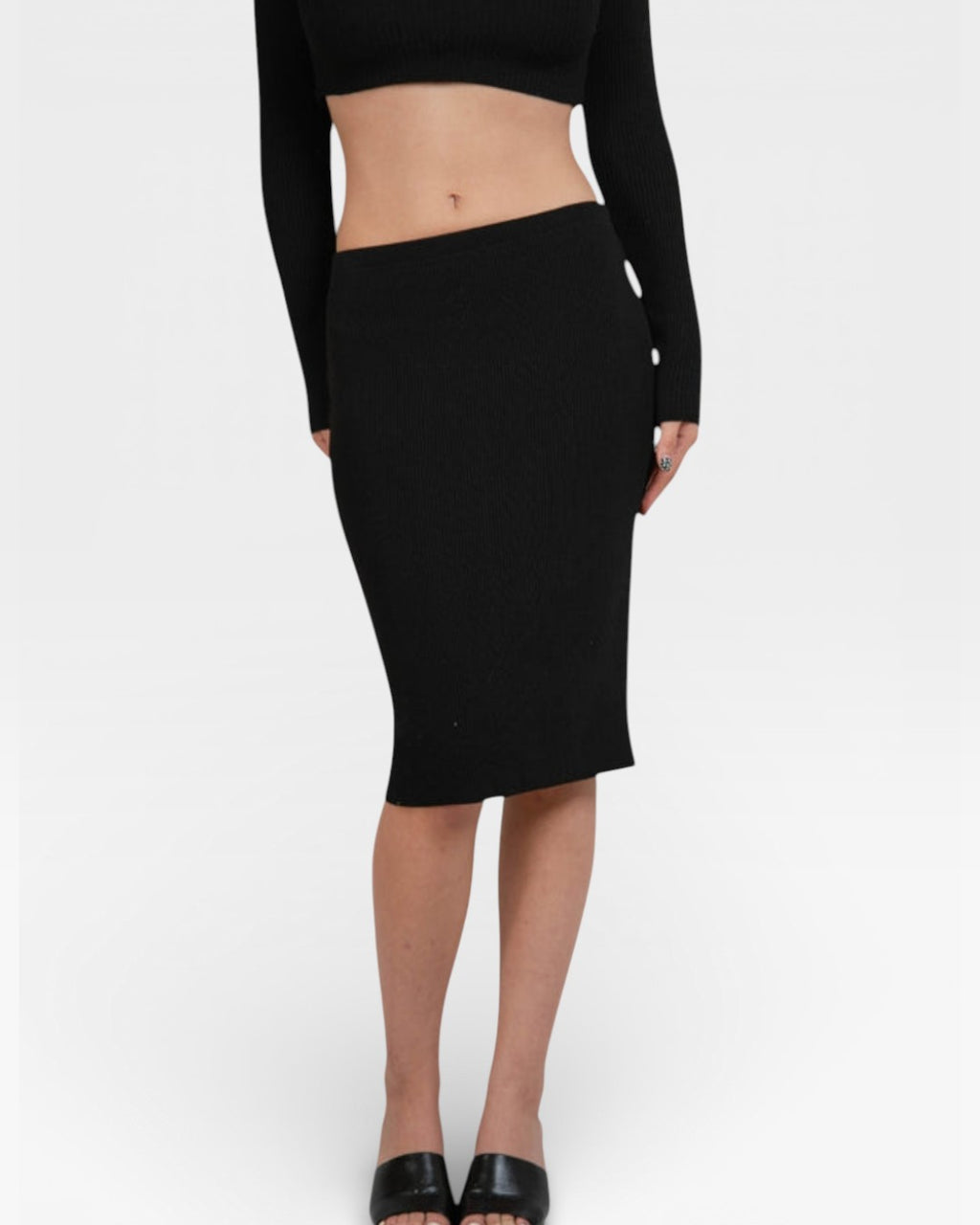 Person wearing a rib knit long-sleeve top and fitted pencil midi skirt in Ink black by The Knit House LAon a white background