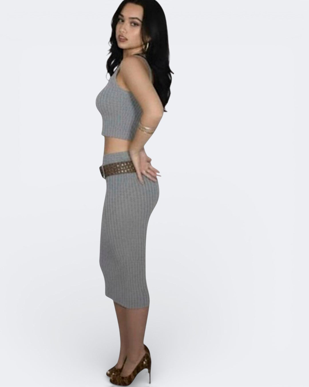 Woman wearing a Mist gray ribbed tank and fitted pencil skirt with a belt on a white background