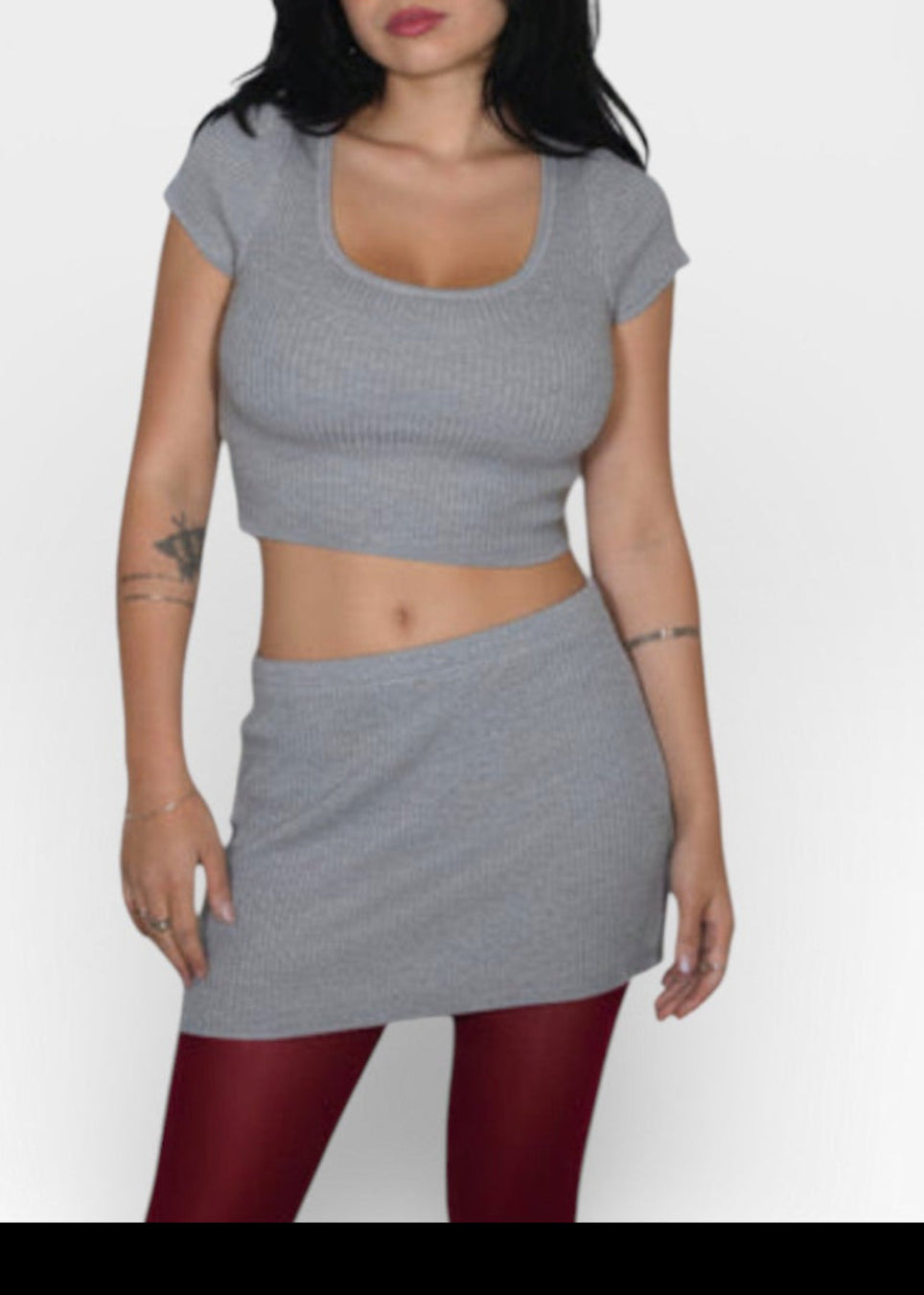 Woman wearing a Mist gray crop top and rib knit mini skirt set by The Knit House LA.