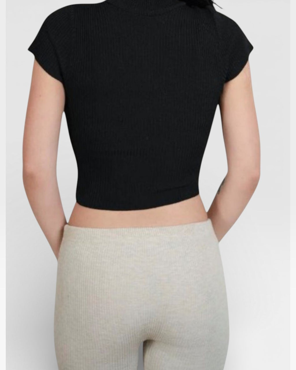 back view of fitted rib knit capri pant with side slit in Drift beige by The Knit House LA.