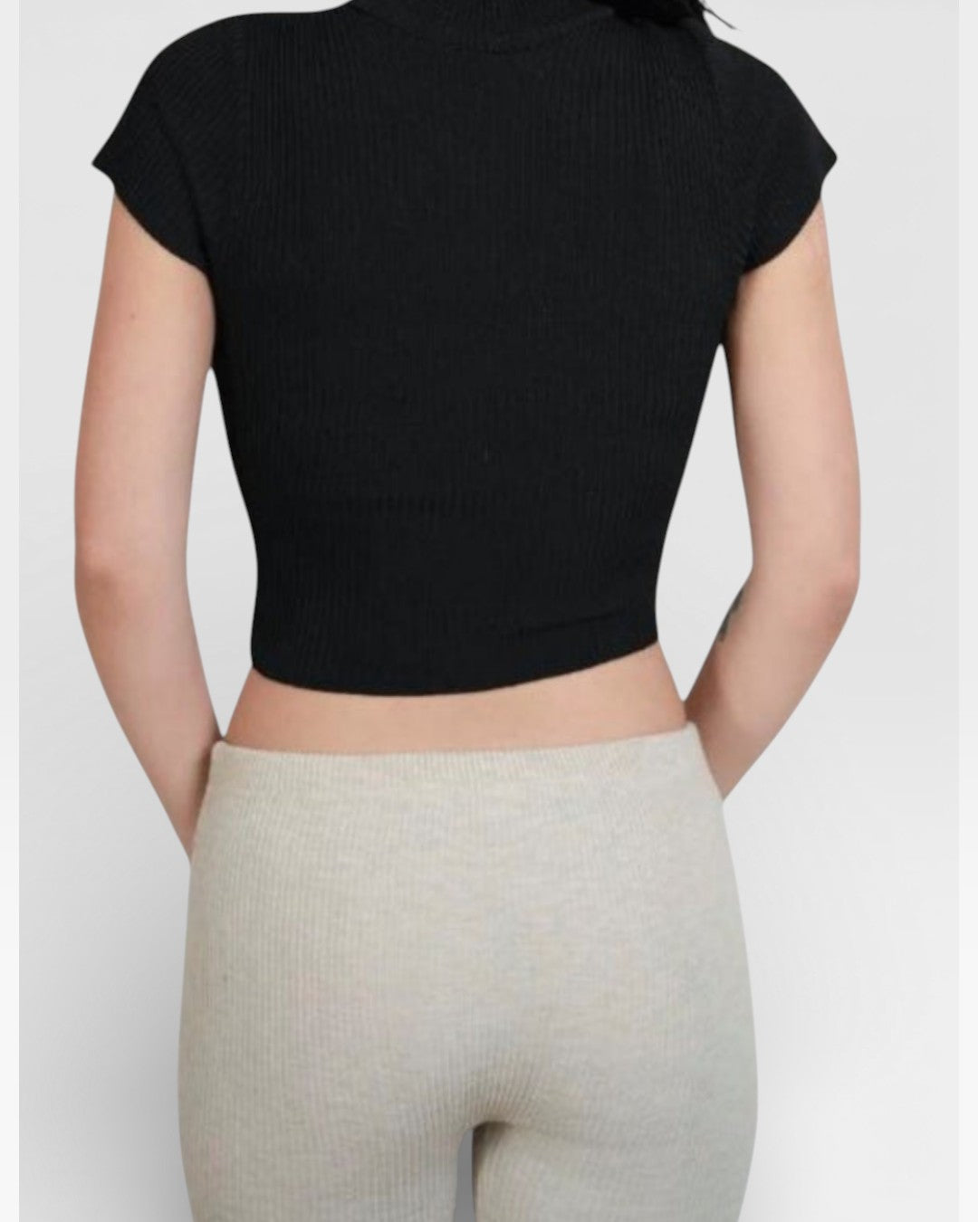 back view of fitted rib knit capri pant with side slit in Drift beige by The Knit House LA.