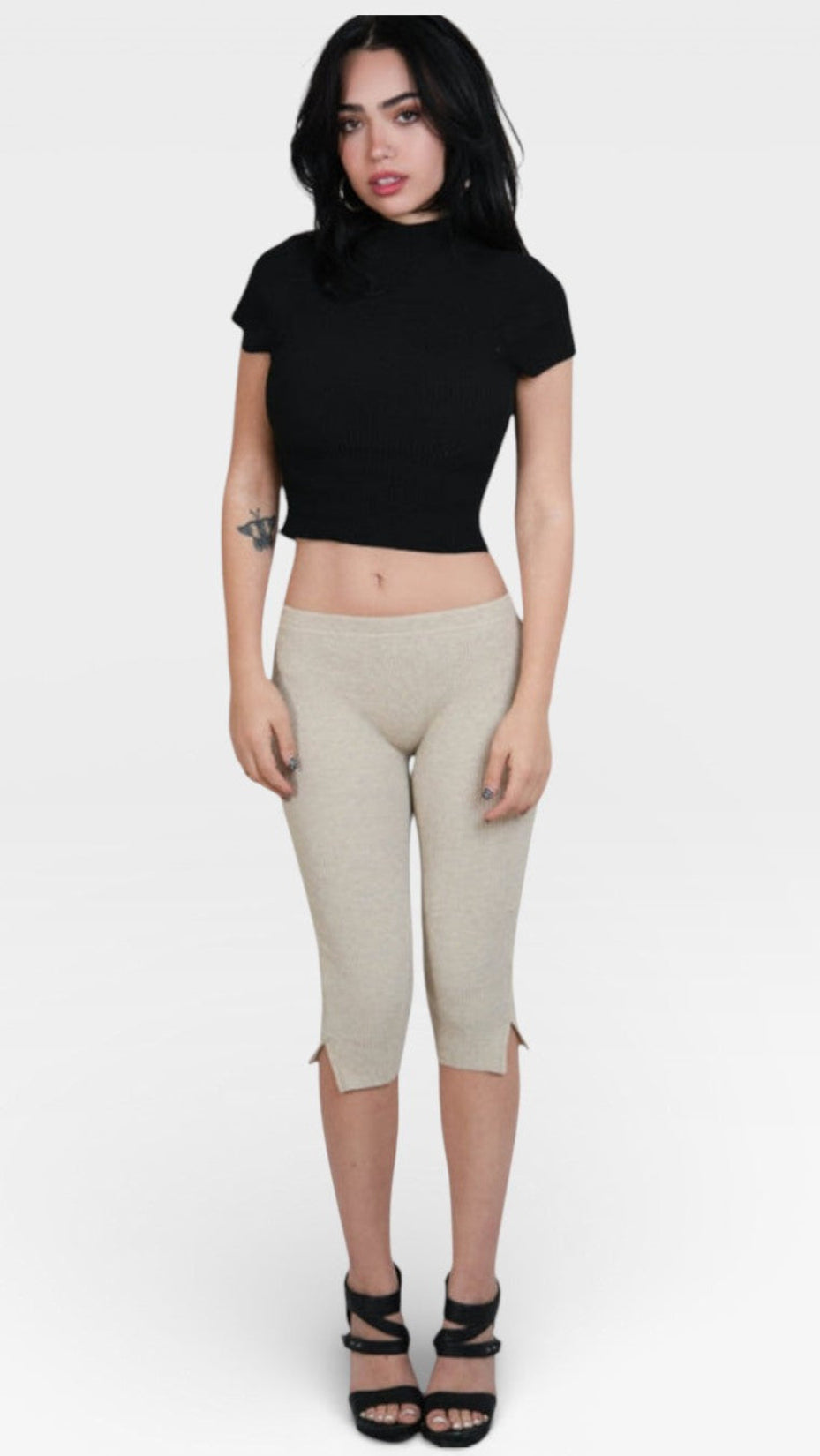 woman wearing fitted rib knit capri pant with side slit in Drift beige by The Knit House LA.