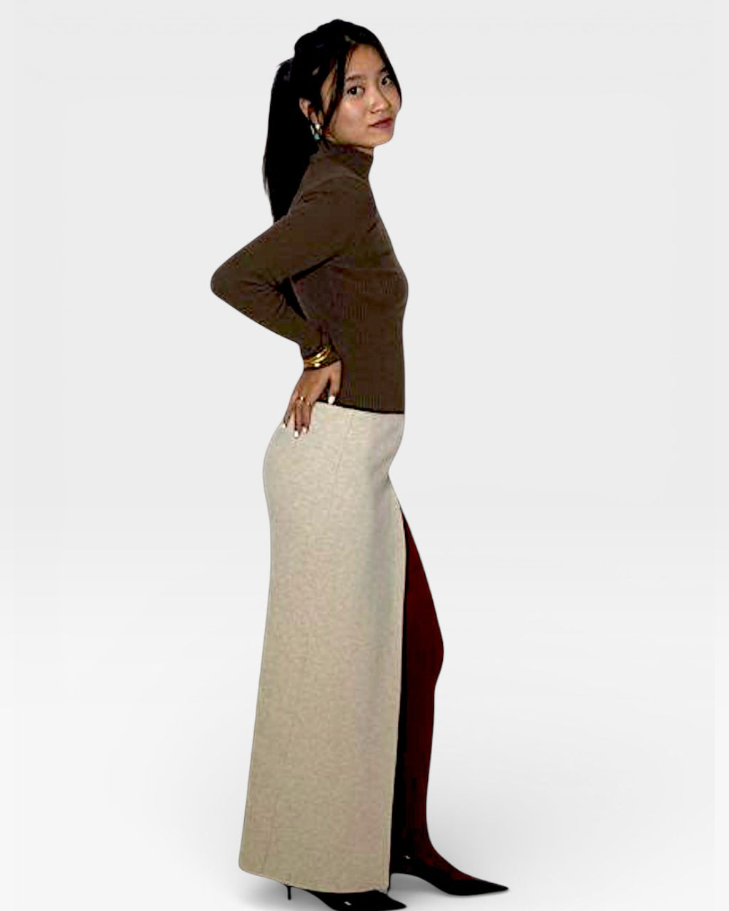 Woman wearing a rib knit brown turtleneck with long maxi skirt with center front slit in Drift Beige by The Knit House LA