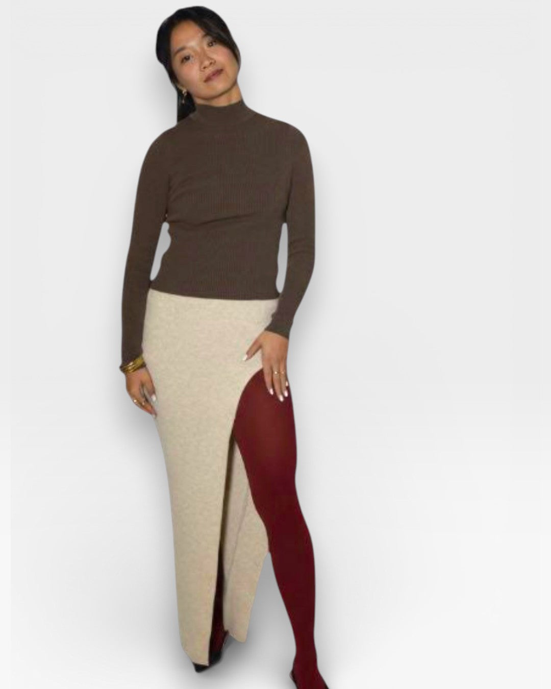 Woman wearing a rib knit brown turtleneck with long maxi skirt with center front slit in Drift Beige by The Knit House LA