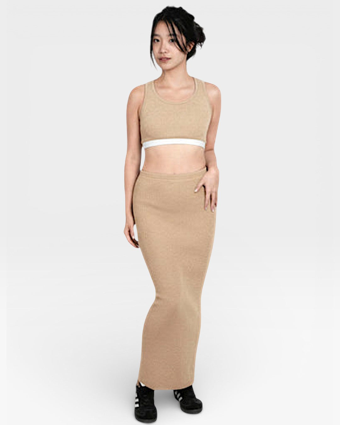 Woman wearing fitted ribbed knit long pencil tube skirt with crop tank top in Drift Beige by The Knit House LA.