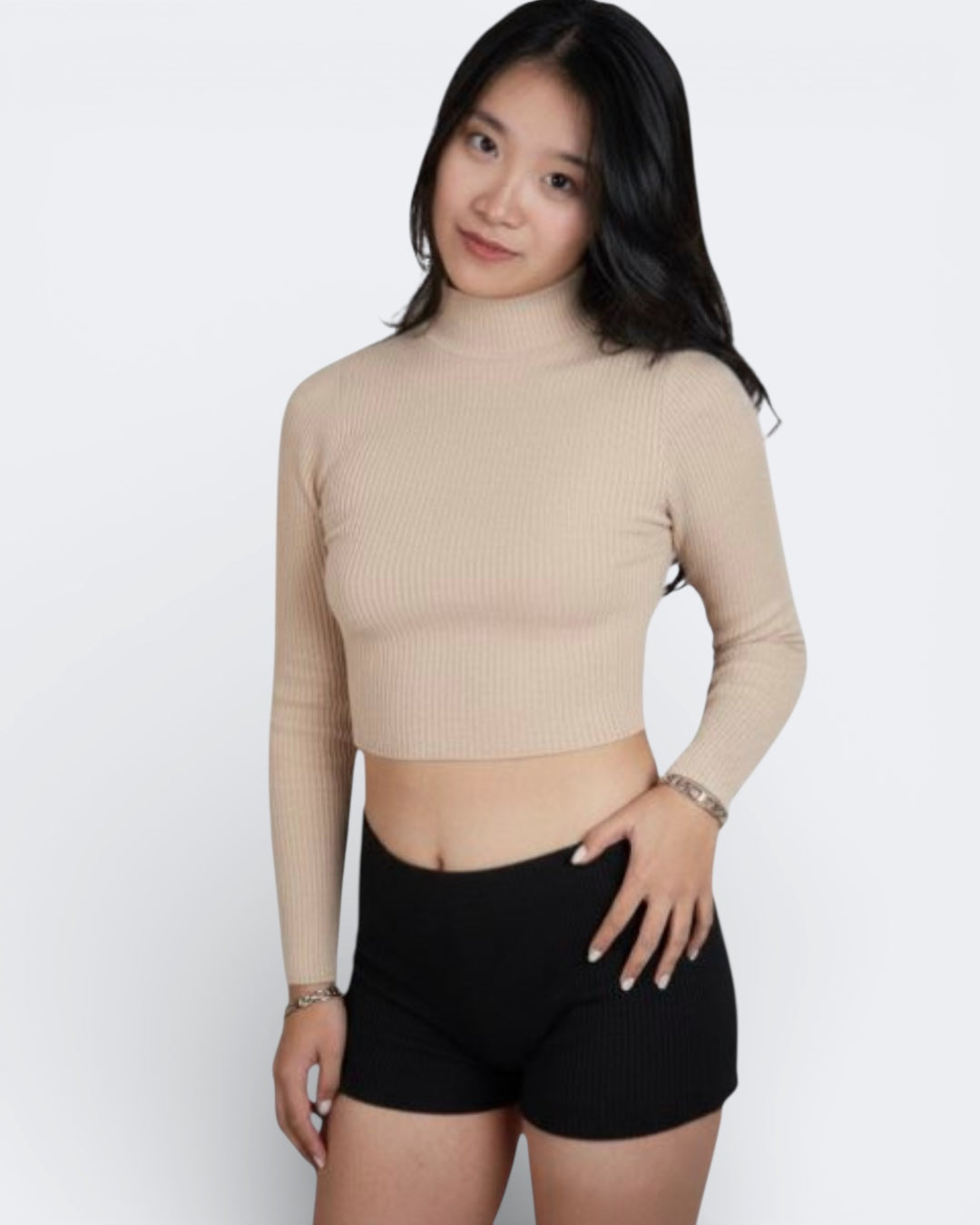 Woman wearing a fitted rib knit long sleeve crop top in Drift beige by The Knit House LA.