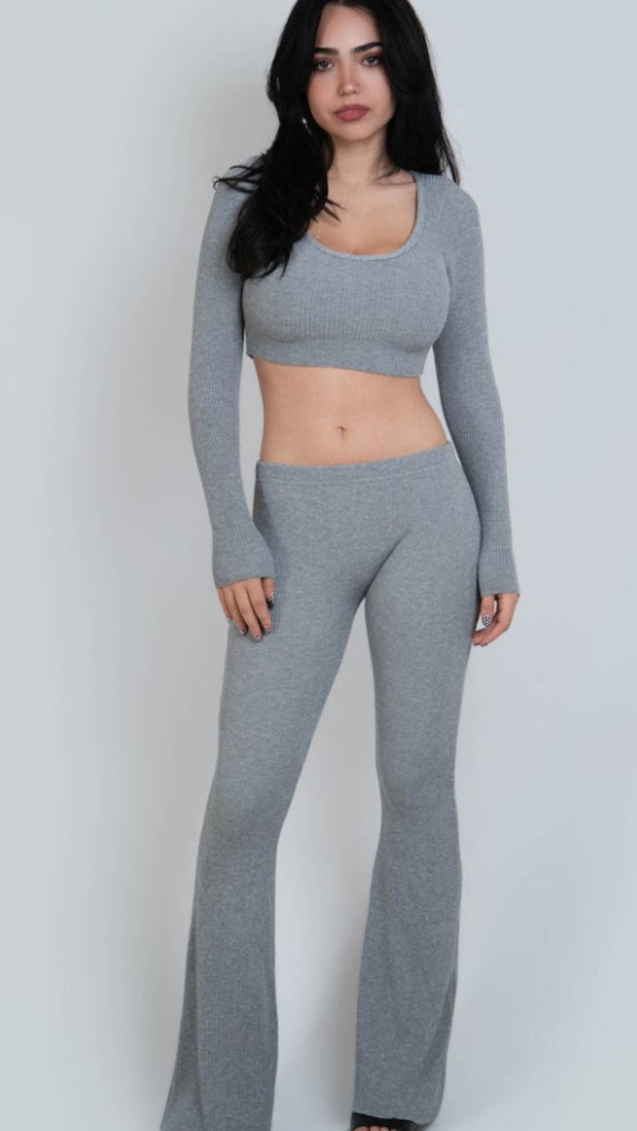 Woman wearing a gray outfit on a white background