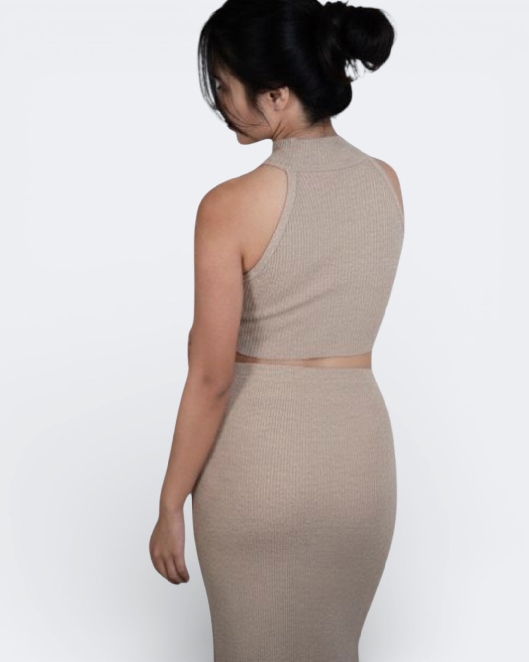 woman wearing a sleeveless fitted rib crop shell with high neck in Drift beige by The Knit House La.