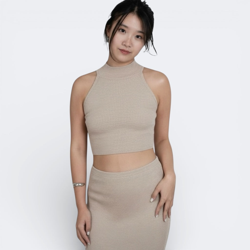 woman wearing a sleeveless fitted rib crop shell with high neck in Drift beige by The Knit House La.