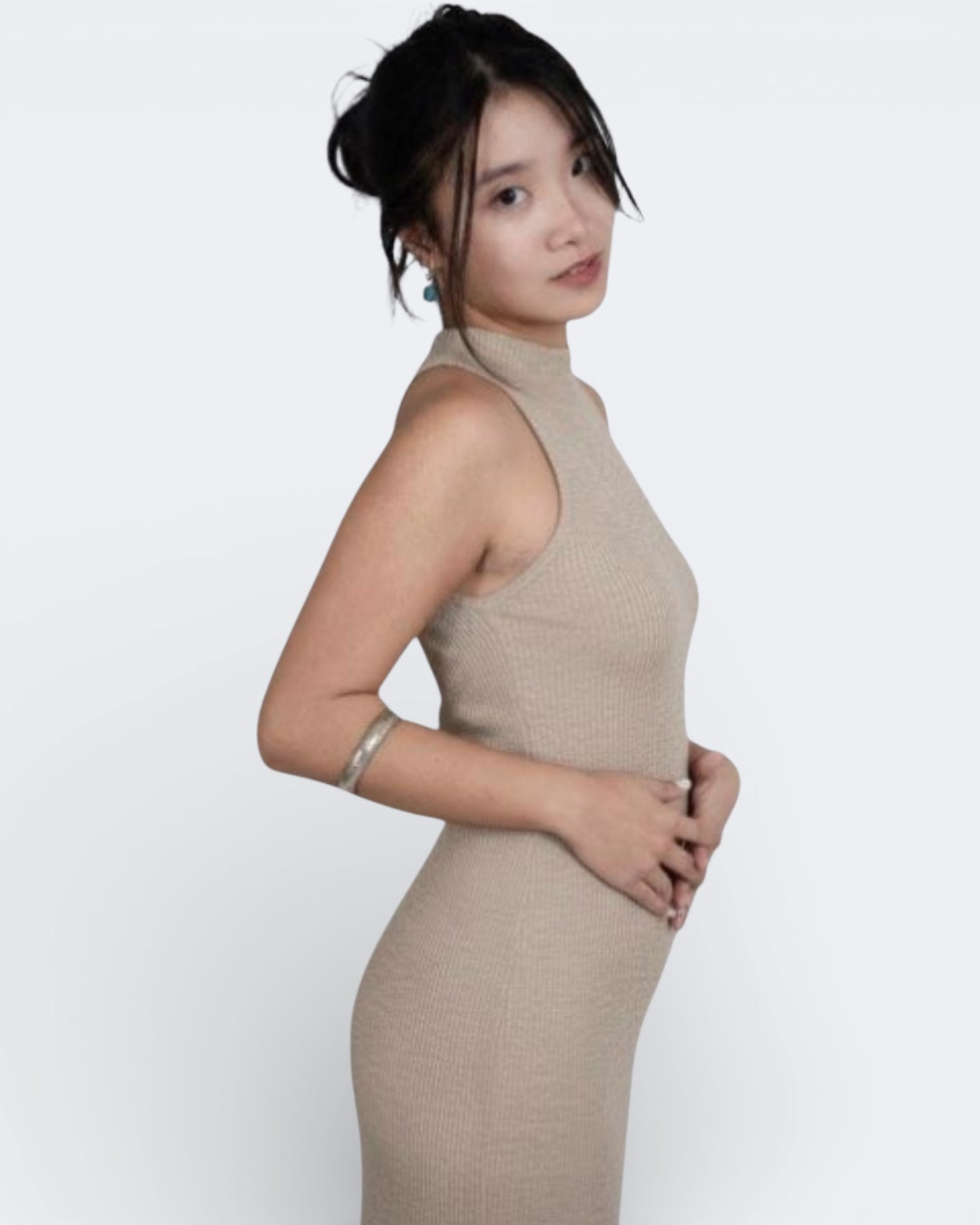 woman wearing a sleeveless fitted rib crop shell with high neck in Drift beige by The Knit House La.