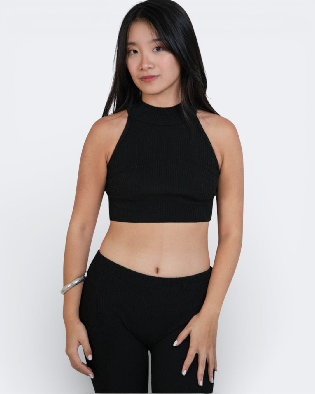 woman wearing a sleeveless fitted rib crop shell with high neck in Ink Black by The Knit House La.