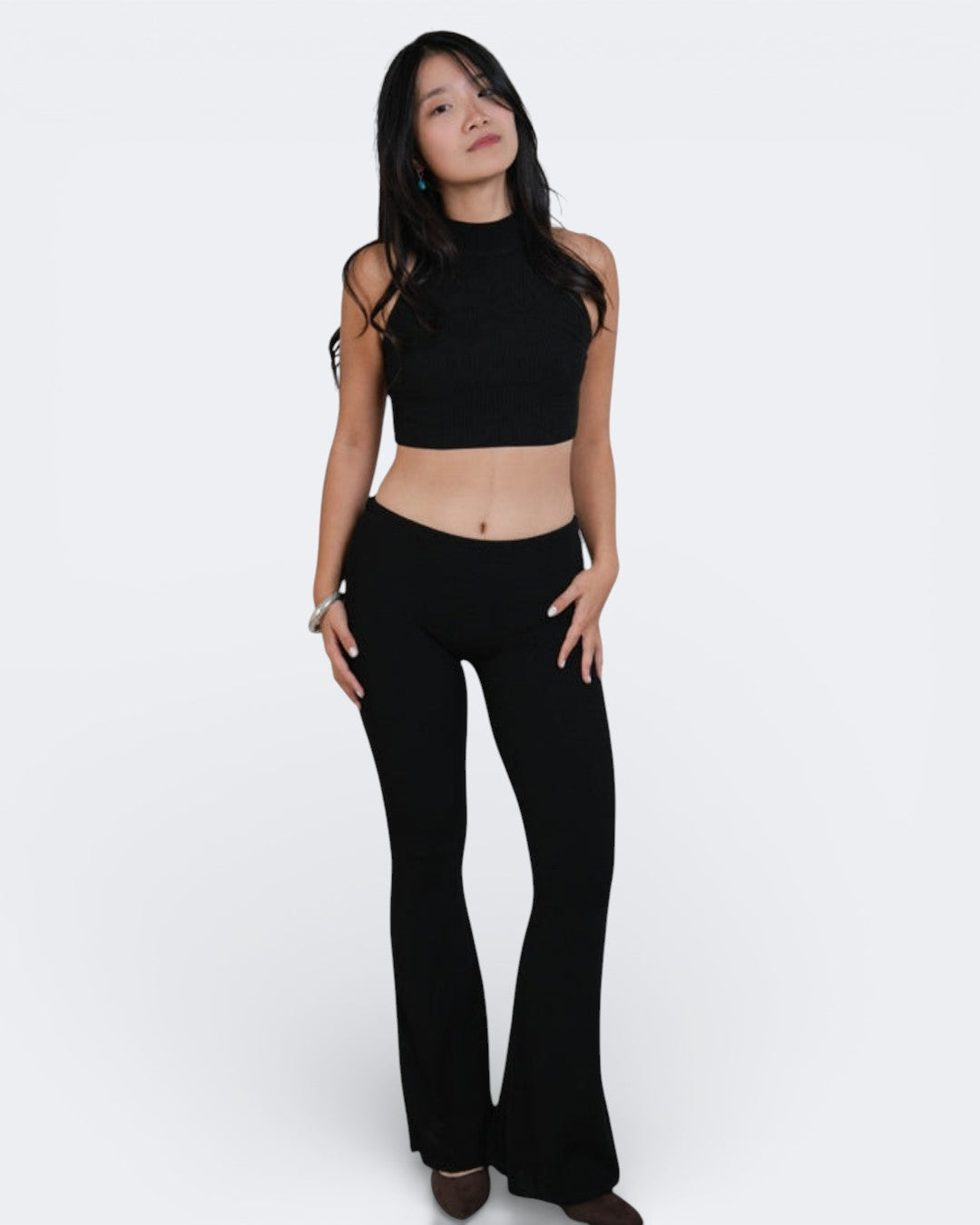 woman wearing a sleeveless fitted rib crop shell with high neck in Ink Black by The Knit House La.