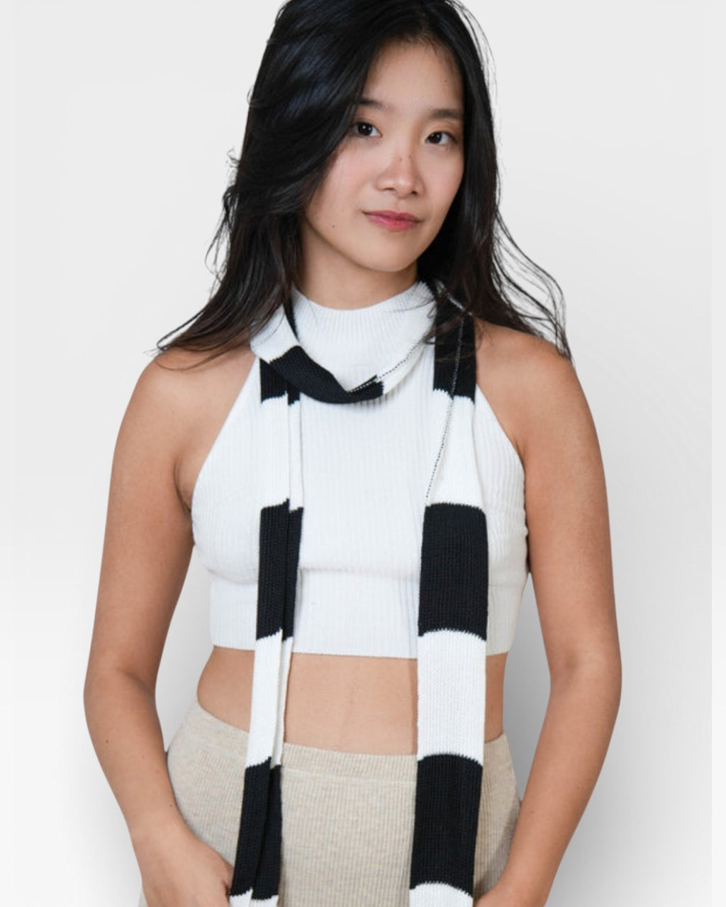 woman wearing a sleeveless fitted rib crop shell with high neck in Porcelain white by The Knit House La.
