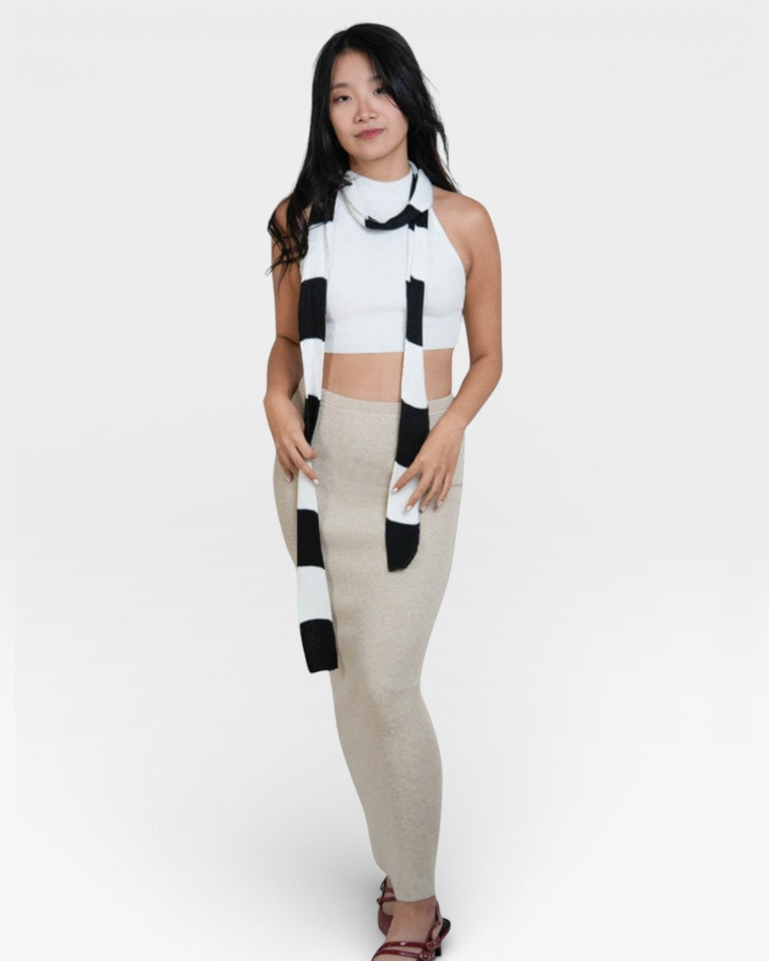 woman wearing a sleeveless fitted rib crop shell with high neck in Porcelain white by The Knit House La.