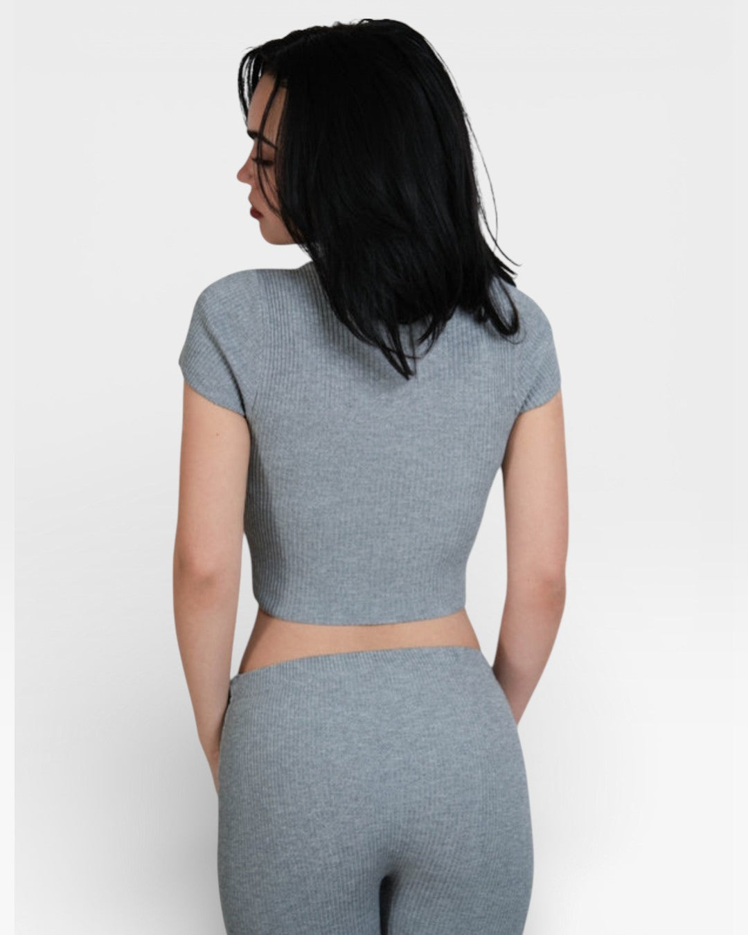 Woman wearing fitted rib crop top with short sleeves and high neck in Mist grey by The Knit House LA.