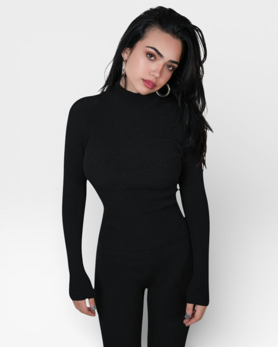 Woman wearing a black long-sleeve top against a white background