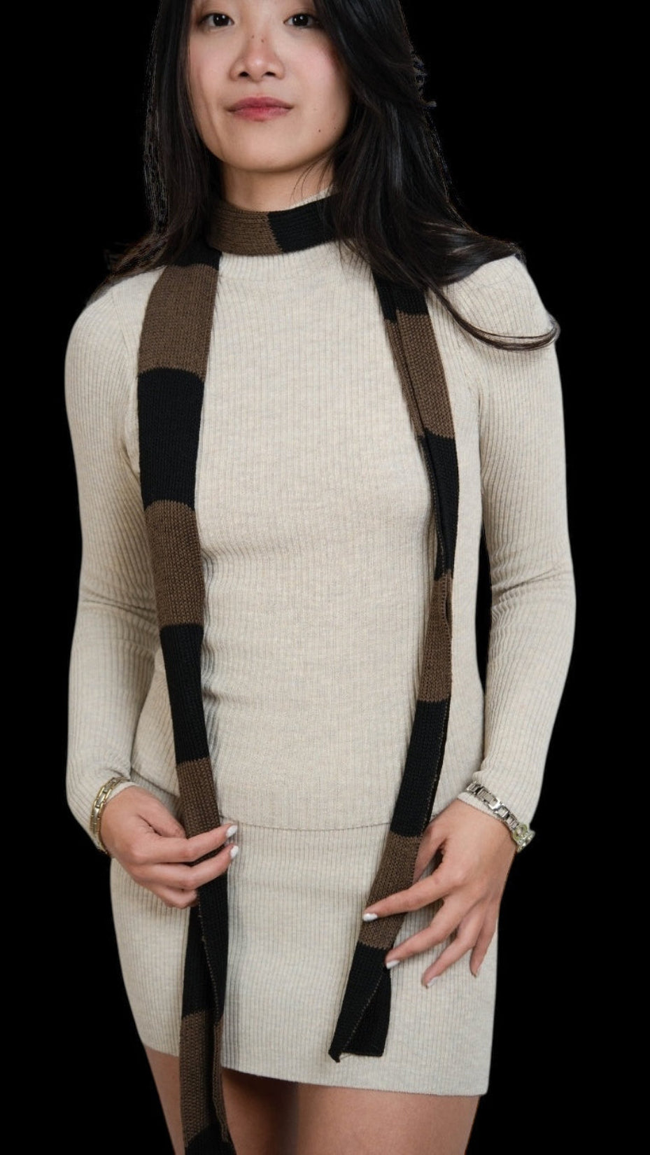 Woman wearing extra long skinny knit scarf in Bark brown and Coal black by The Knit House LA.