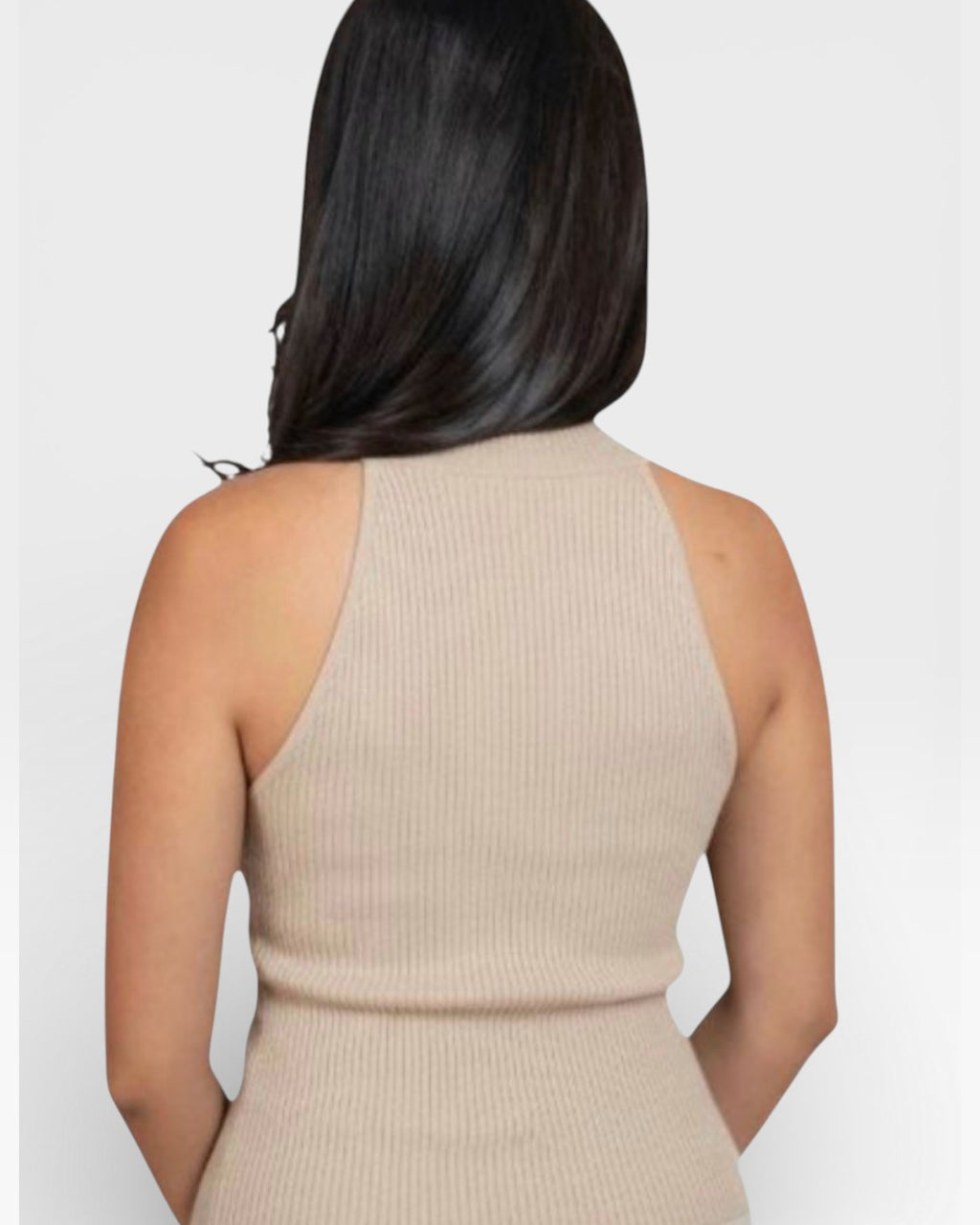 Back view of woman wearing a high necked fitted rib sleeveless knit shell in Drift beige by The Knit House LA.