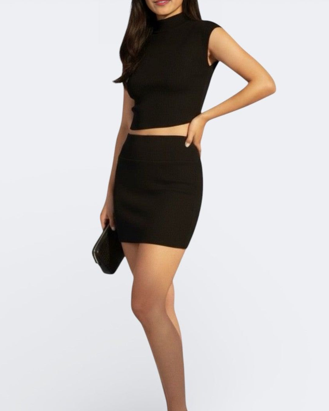 Woman wearing fitted short sleeve rib knit top with high neck in Ink black by The Knit House LA.