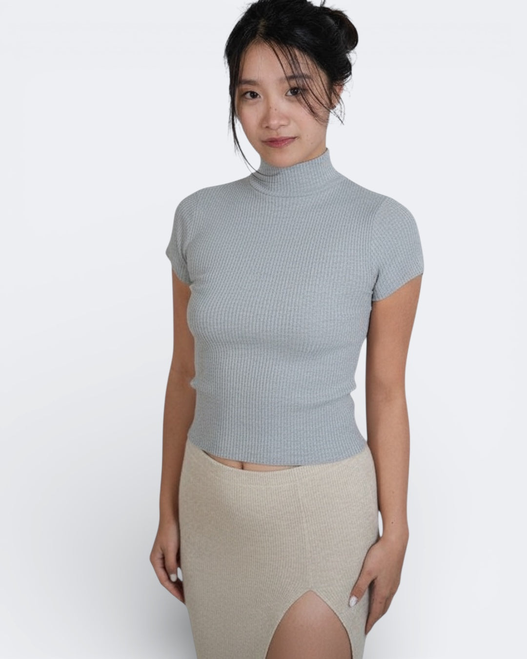 Woman wearing fitted knit short sleeve top with high neck in Mist grey by The Knit House LA.