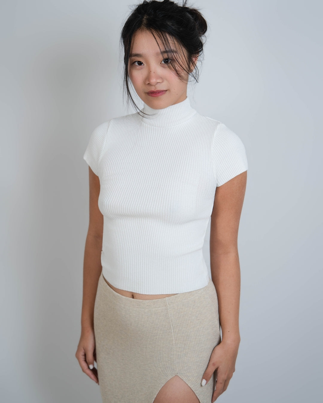 Woman wearing fitted rib knit short sleeve top in Porcelain white by The Knit House LA.