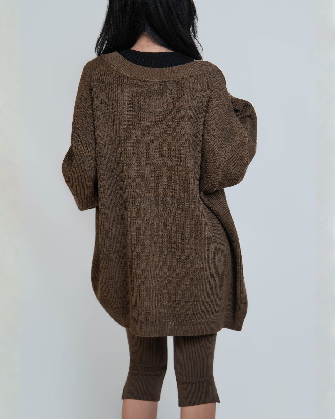 back view of woman wearing relaxed rib cardigan with patch pockets in Bark brown by The Knit House LA.