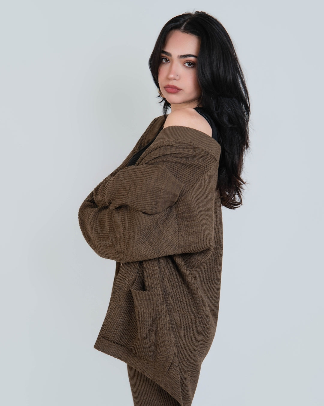 Side view ​woman wearing relaxed rib cardigan with patch pockets in Bark brown by The Knit House LA.