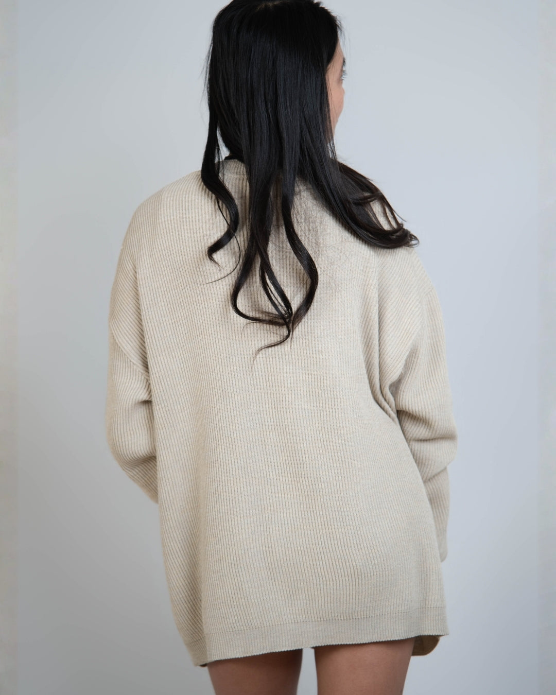 Woman wearing rib knit relaxed cardigan in Neutral beige by The Knit House LA.