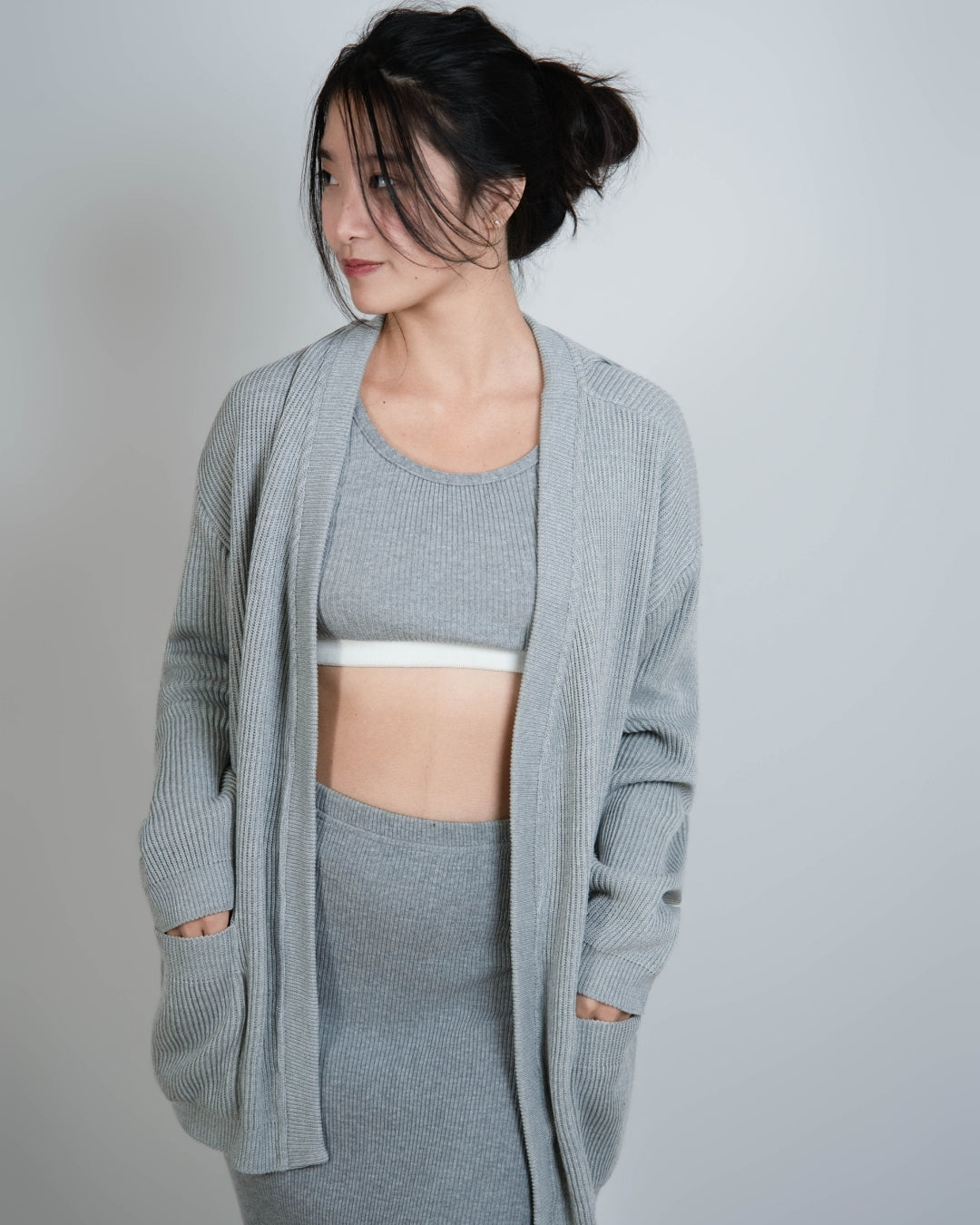 woman wearing rib knit relaxed oversized cardigan in Mist grey by The Knit House LA.